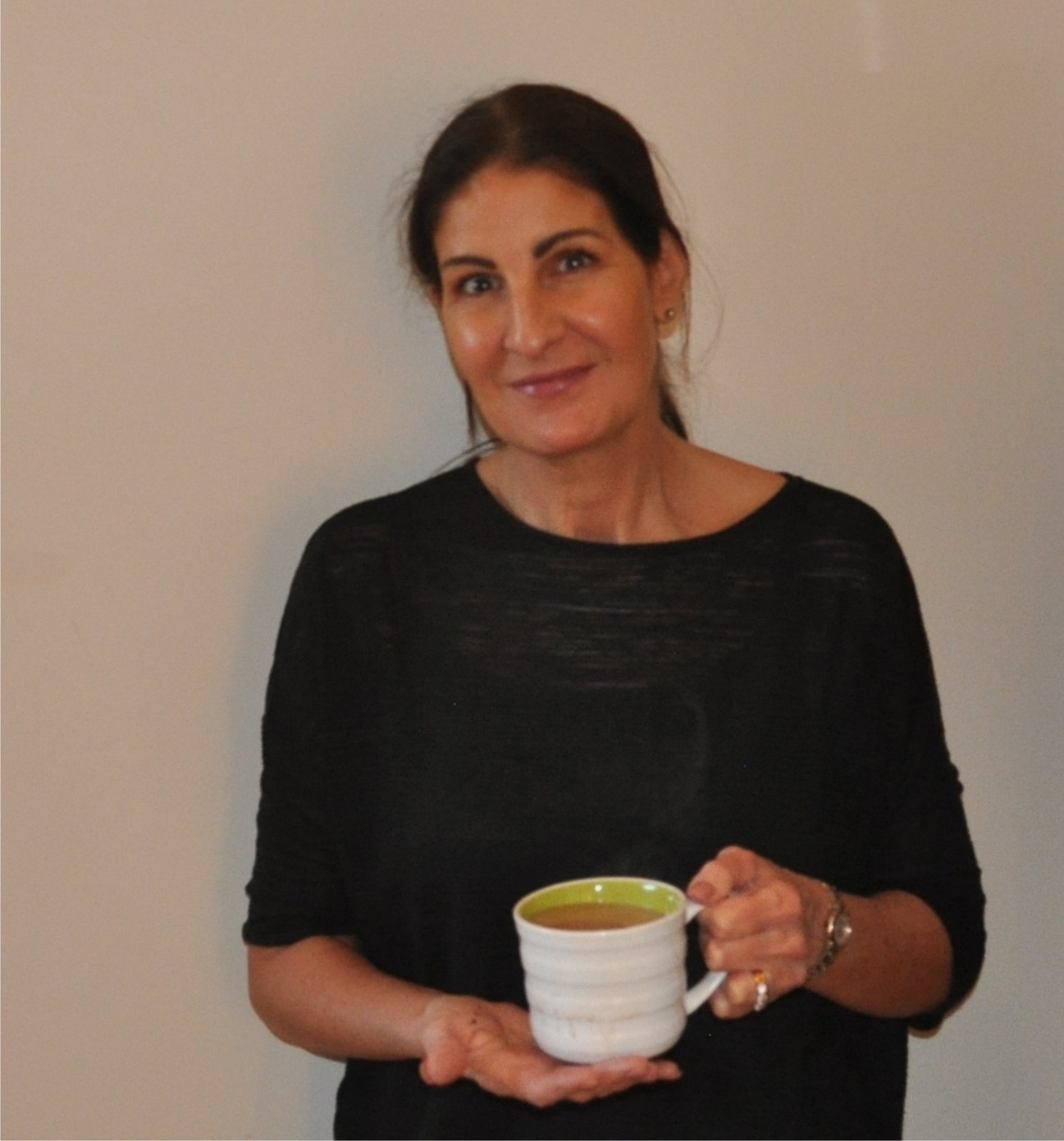 Allison McCarron smiling, holding a mug