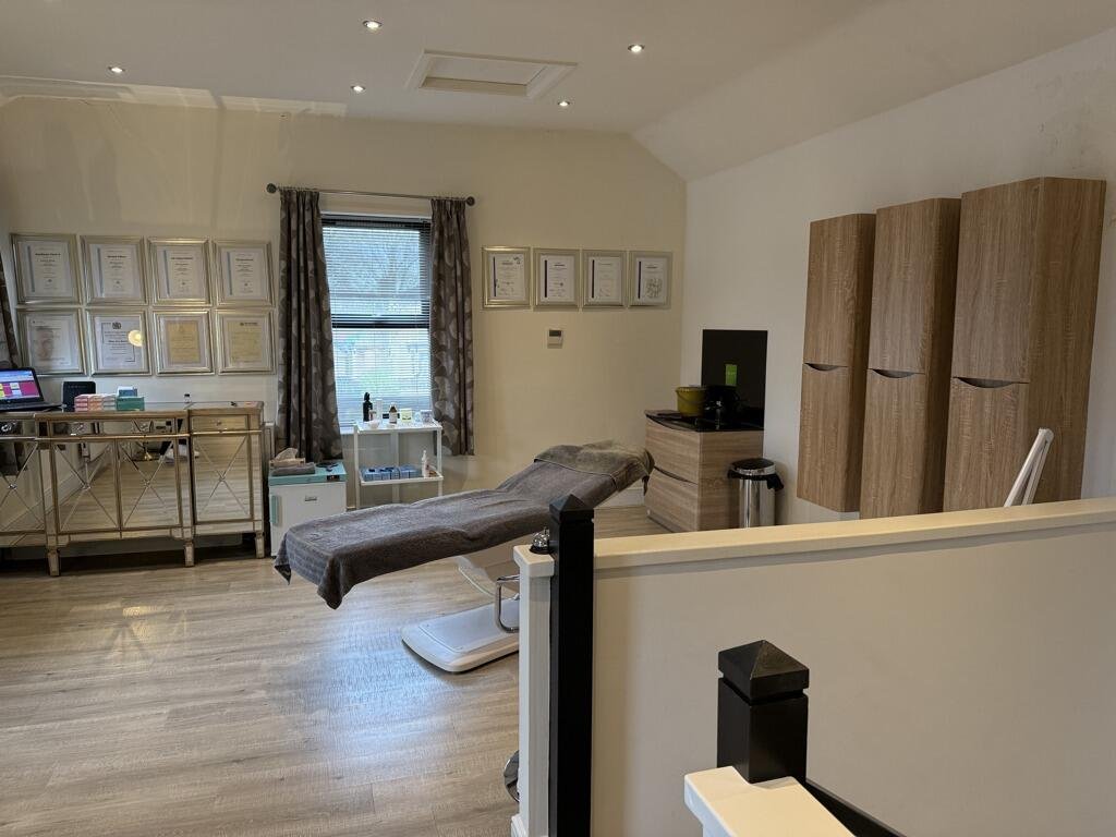 The treatment room, with a treatment couch and Allison's framed certificates on the wall