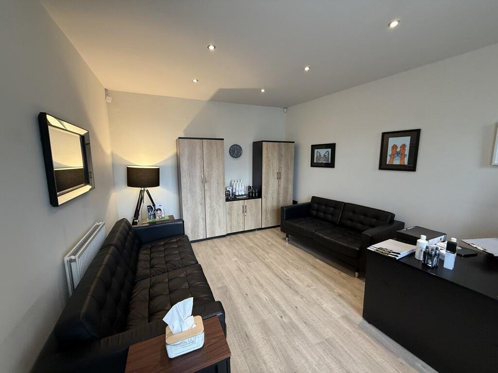 The clinic waiting room with leather sofas and soft lighting